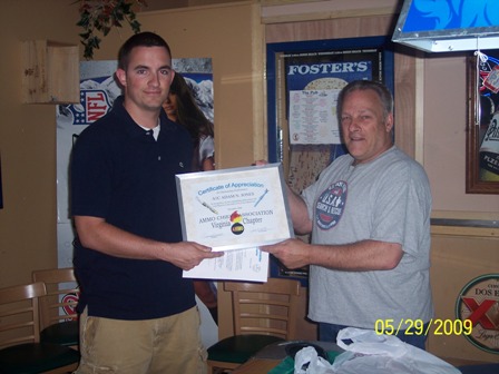Airman Jones is  presented the ACAMC Outstanding AMMO Performer Award by AMMO Chief (Ret) Frank Waterman